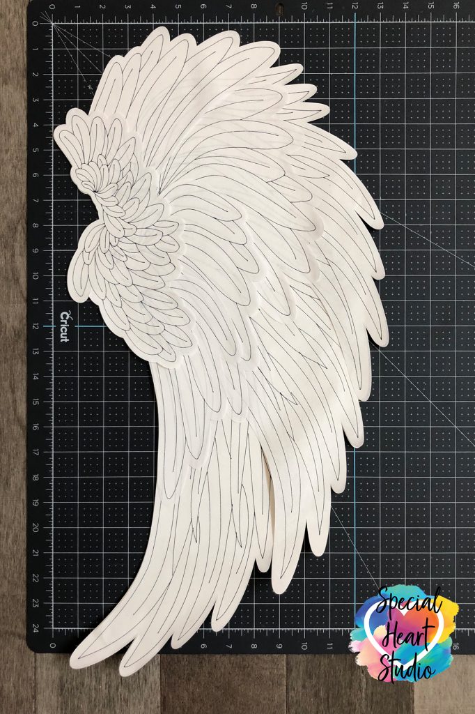 26 inch tall Angel Wing made of paper with Cricut Machine. Black outline of feathers