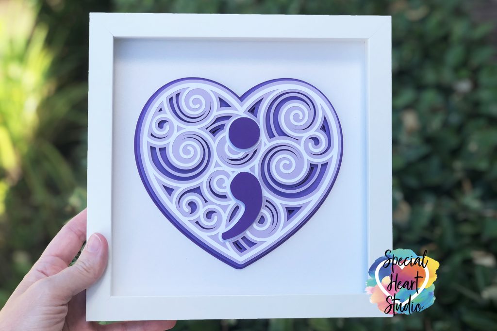 White Framed Purple heart made of layers of card stock with swirls and a semicolon