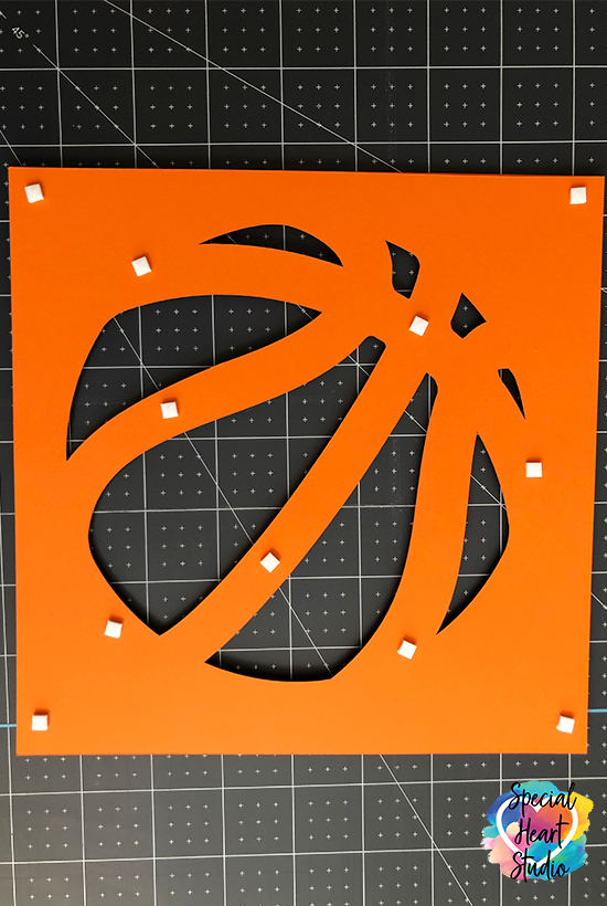 Back side of one layer of basketball cut on a cricut. Foam tab placement.