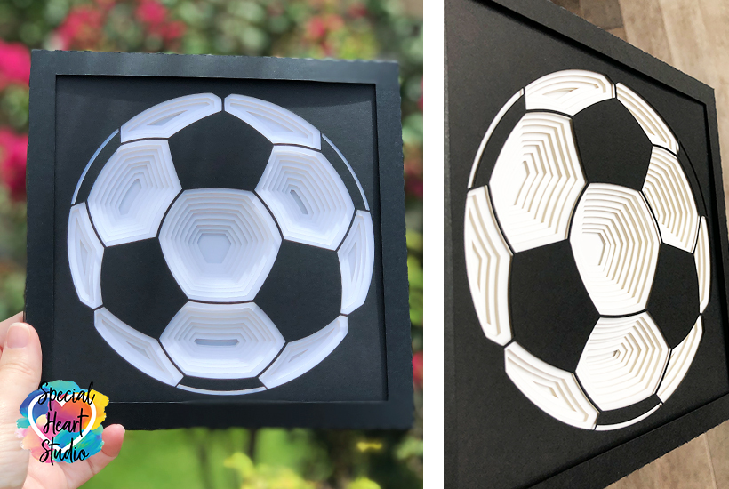 Layered soccer ball shadow box front and side angle view.