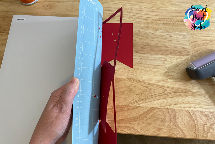 Remove paper from Cricut mat by turning upside down and gently bend mat away from paper