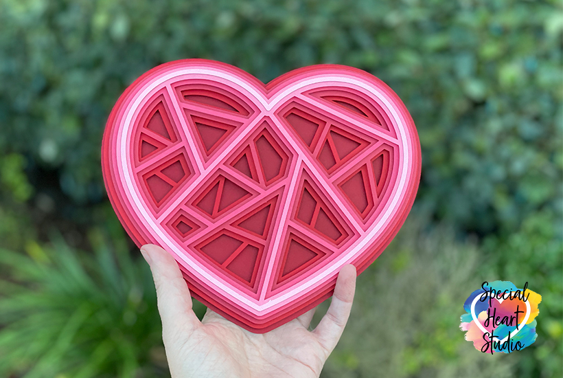 Layered Geometric Heart cut from cardstock in shades of red and pink.